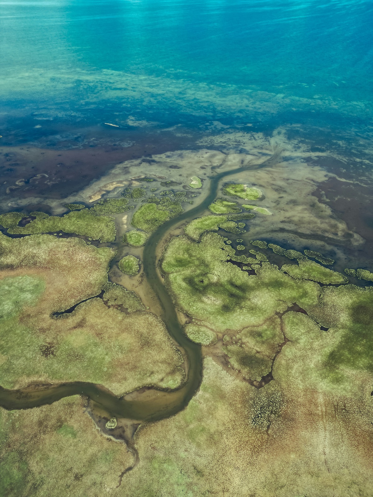 Aerial view of land shaped by artisanal mining and agriculture